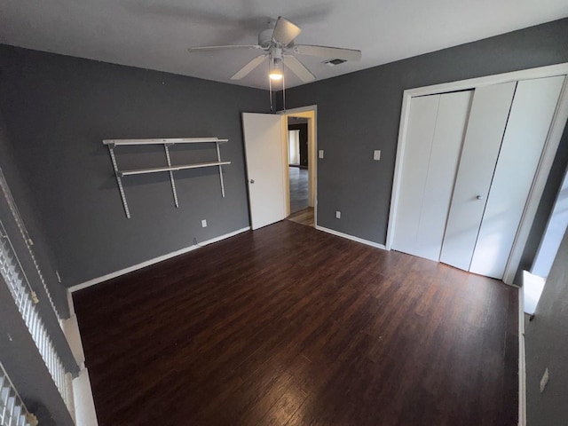 unfurnished bedroom with ceiling fan, wood-type flooring, and a closet