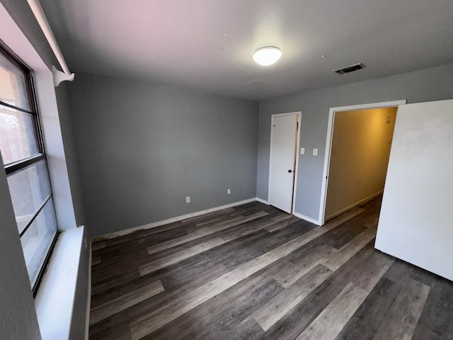 spare room featuring dark hardwood / wood-style flooring