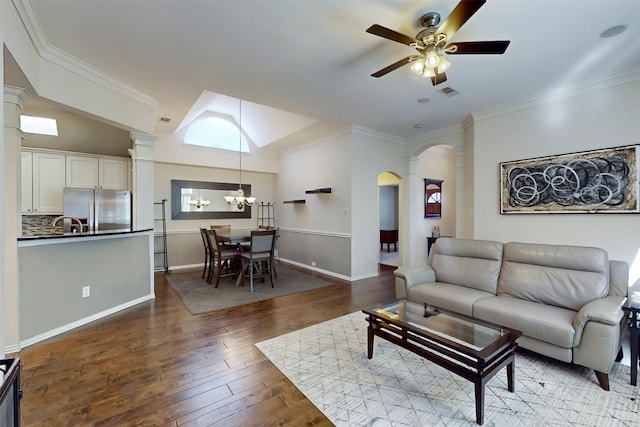 living room featuring ornate columns, crown molding, hardwood / wood-style floors, and ceiling fan with notable chandelier