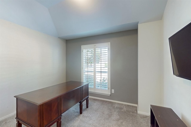 carpeted office with vaulted ceiling