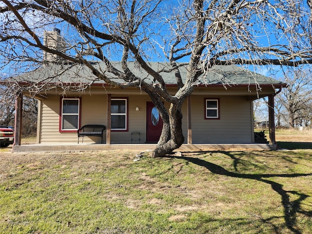 ranch-style home with a patio area and a front lawn