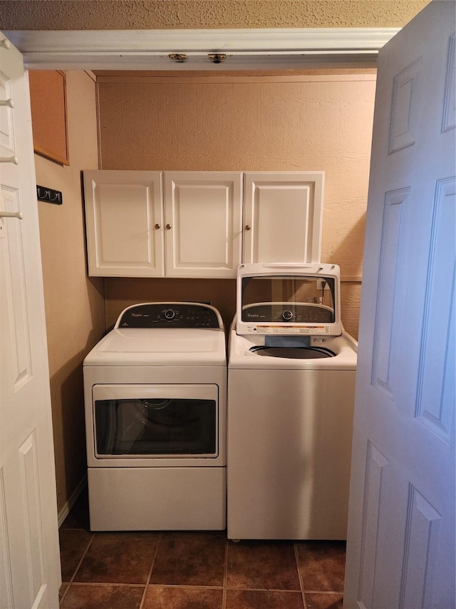 clothes washing area with washer and dryer and cabinets