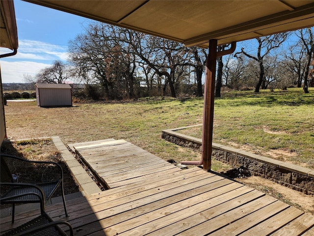 wooden deck featuring a lawn and a storage unit