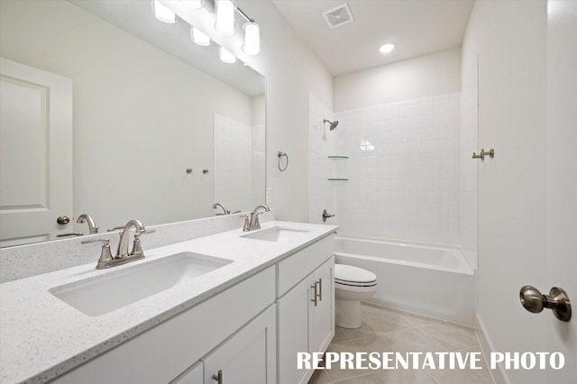 full bathroom with vanity, tile patterned floors, toilet, and washtub / shower combination