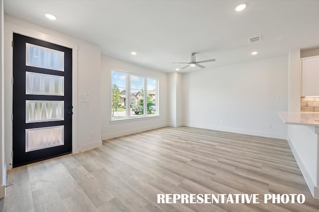 entryway with ceiling fan and light wood-type flooring