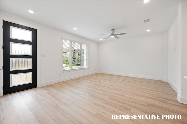 foyer with ceiling fan and light hardwood / wood-style flooring