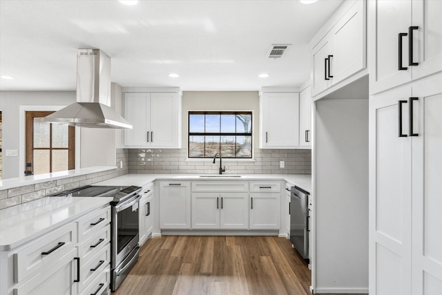 kitchen with white cabinetry, appliances with stainless steel finishes, and island range hood