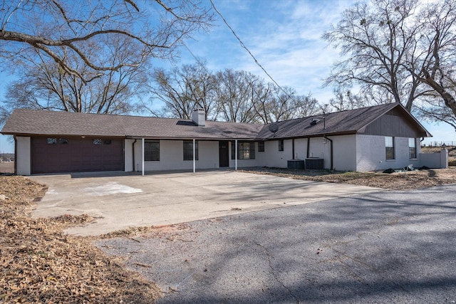 view of front of property with cooling unit and a garage