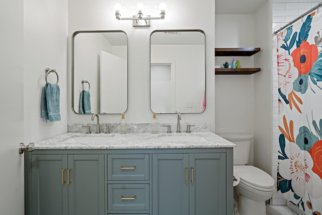 bathroom with vanity, toilet, and walk in shower