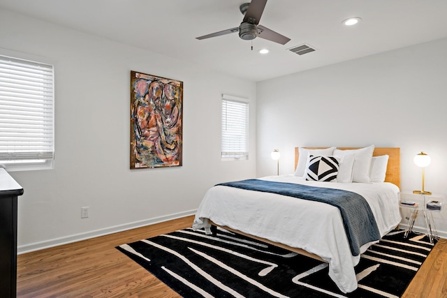 bedroom with wood-type flooring and ceiling fan