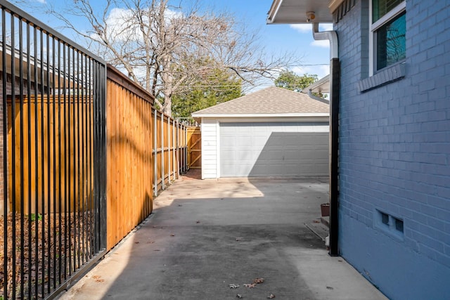 view of side of home featuring a garage and an outdoor structure