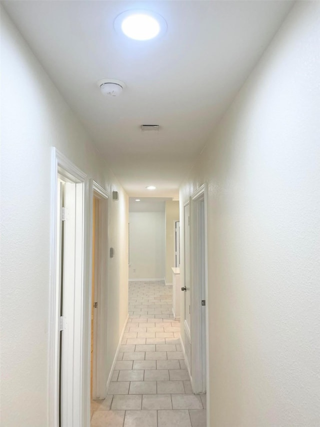 hallway featuring light tile patterned floors