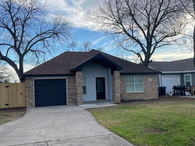 ranch-style house featuring a garage and a front lawn