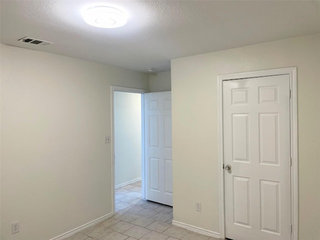 unfurnished bedroom with a closet and a textured ceiling