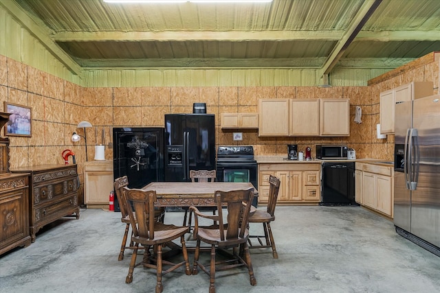 kitchen with light brown cabinetry, beam ceiling, and black appliances