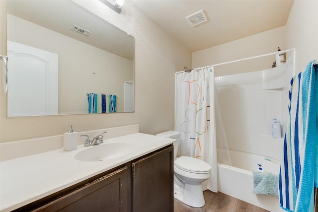 full bathroom with vanity, hardwood / wood-style floors, shower / tub combo with curtain, and toilet