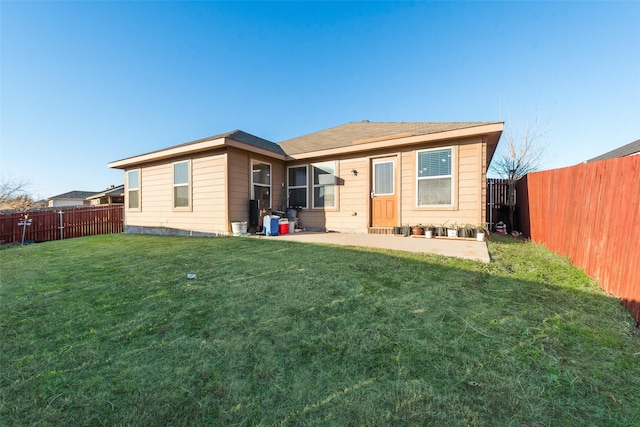 rear view of property featuring a lawn and a patio