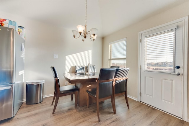 dining area with a chandelier and light wood-type flooring