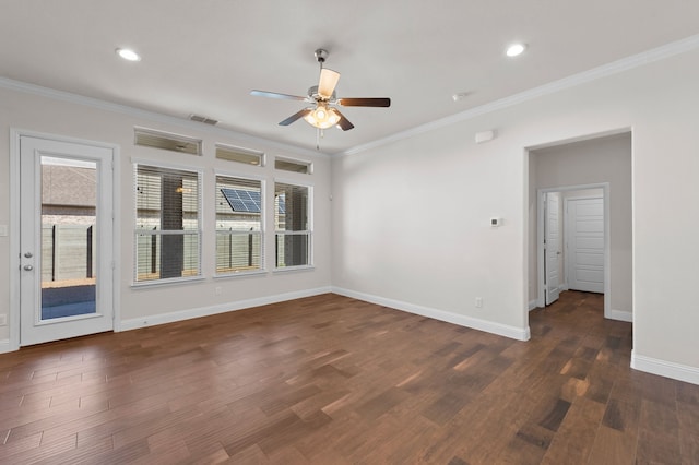 empty room featuring crown molding, dark wood-type flooring, and ceiling fan