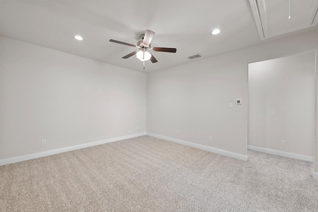 carpeted spare room featuring ceiling fan