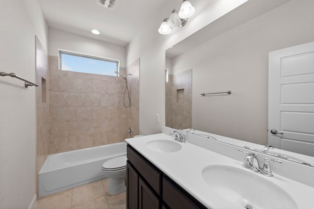 full bathroom featuring vanity, tile patterned floors, toilet, and tiled shower / bath