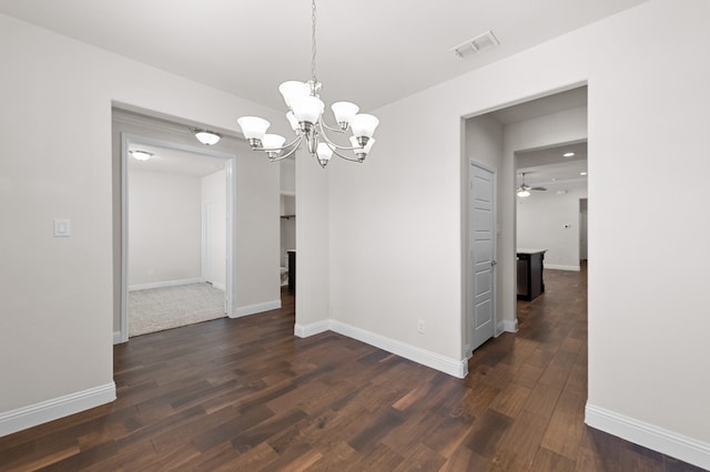 unfurnished dining area with dark wood-type flooring and ceiling fan with notable chandelier