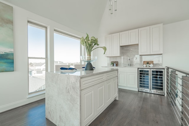 kitchen featuring wine cooler, white cabinetry, plenty of natural light, and dark hardwood / wood-style flooring