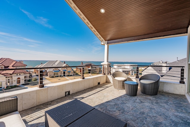 view of patio / terrace featuring a balcony and a water view