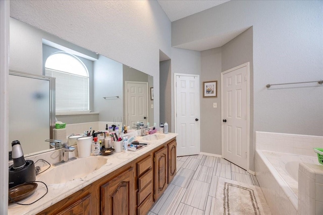 bathroom with vanity and separate shower and tub