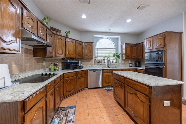 kitchen with a center island, sink, a textured ceiling, and black appliances