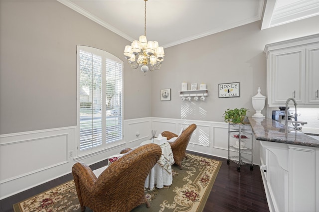 dining room featuring dark hardwood / wood-style flooring, sink, crown molding, and a notable chandelier