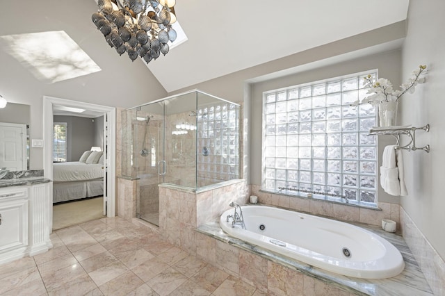 bathroom with vanity, vaulted ceiling, and shower with separate bathtub