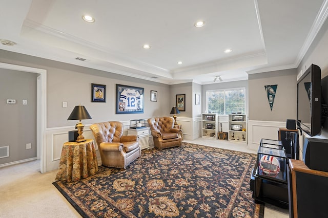 carpeted living room featuring ornamental molding and a tray ceiling