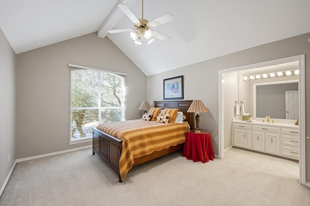 bedroom with lofted ceiling with beams, ceiling fan, connected bathroom, and light colored carpet