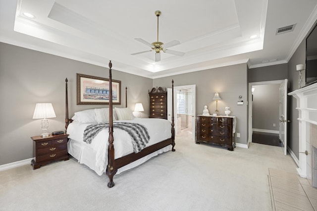 carpeted bedroom with ornamental molding, a raised ceiling, and ceiling fan