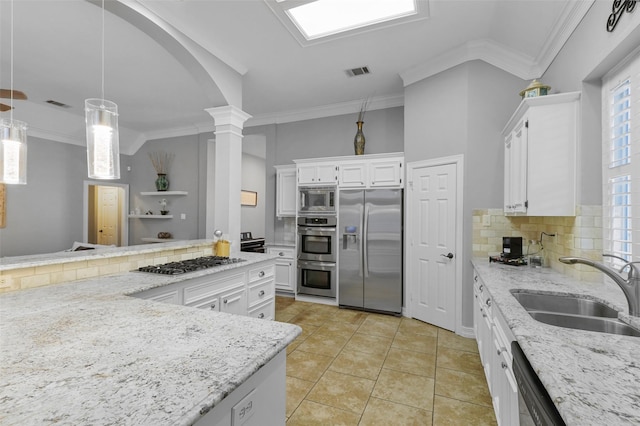 kitchen with sink, white cabinetry, light tile patterned floors, appliances with stainless steel finishes, and pendant lighting