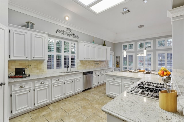 kitchen featuring white cabinetry, sink, decorative light fixtures, and stainless steel appliances