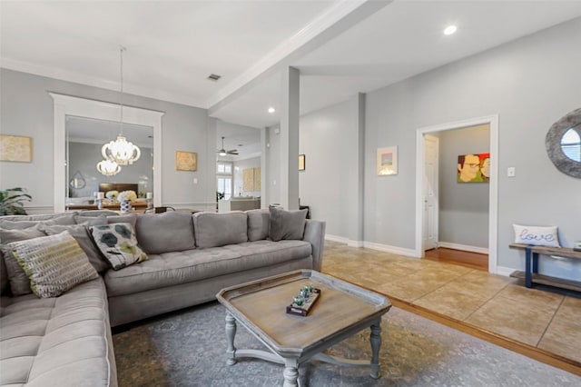 living room featuring ornamental molding, tile patterned floors, and ceiling fan with notable chandelier