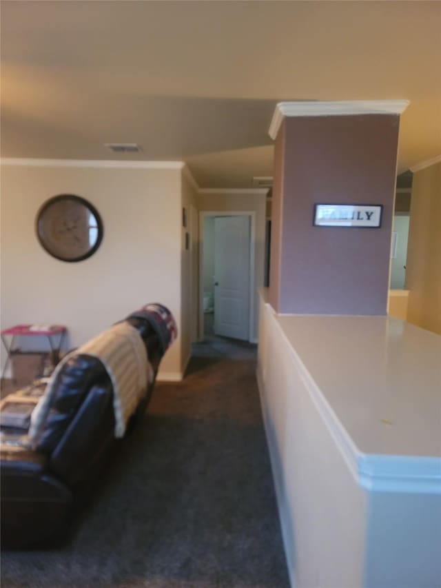 corridor featuring ornamental molding and dark colored carpet