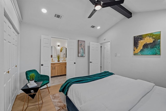 bedroom with connected bathroom, light hardwood / wood-style flooring, a closet, vaulted ceiling with beams, and ceiling fan