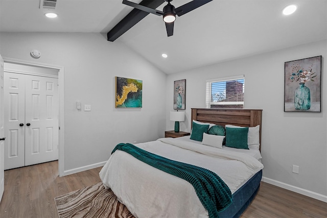 bedroom with ceiling fan, wood-type flooring, and lofted ceiling with beams