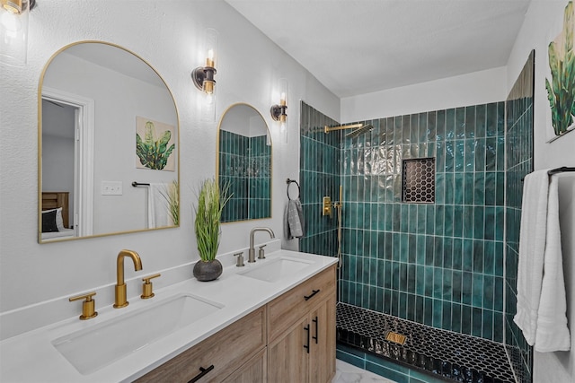 bathroom featuring vanity and tiled shower