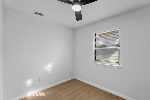 empty room featuring ceiling fan and hardwood / wood-style floors