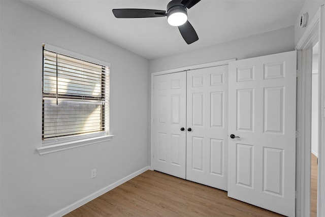 unfurnished bedroom with ceiling fan, a closet, and light hardwood / wood-style floors