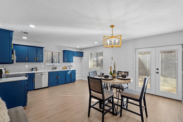 dining area with sink, french doors, a wealth of natural light, and light hardwood / wood-style flooring