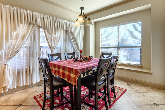 tiled dining area featuring ornamental molding