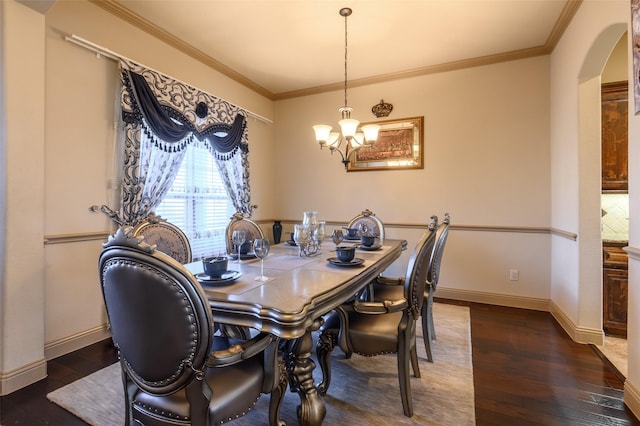 dining area with crown molding, dark wood-type flooring, and a chandelier