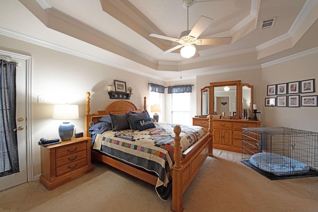 carpeted bedroom featuring crown molding, ceiling fan, and a tray ceiling