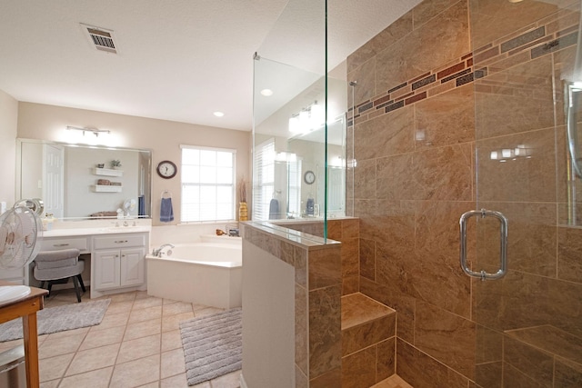 bathroom featuring tile patterned flooring, vanity, and separate shower and tub