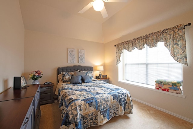 carpeted bedroom featuring ceiling fan and vaulted ceiling